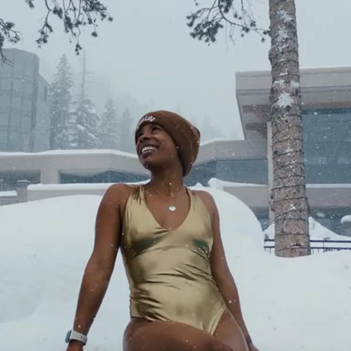 A woman with long dark hair looking to the side, revealing the graceful curve of her back