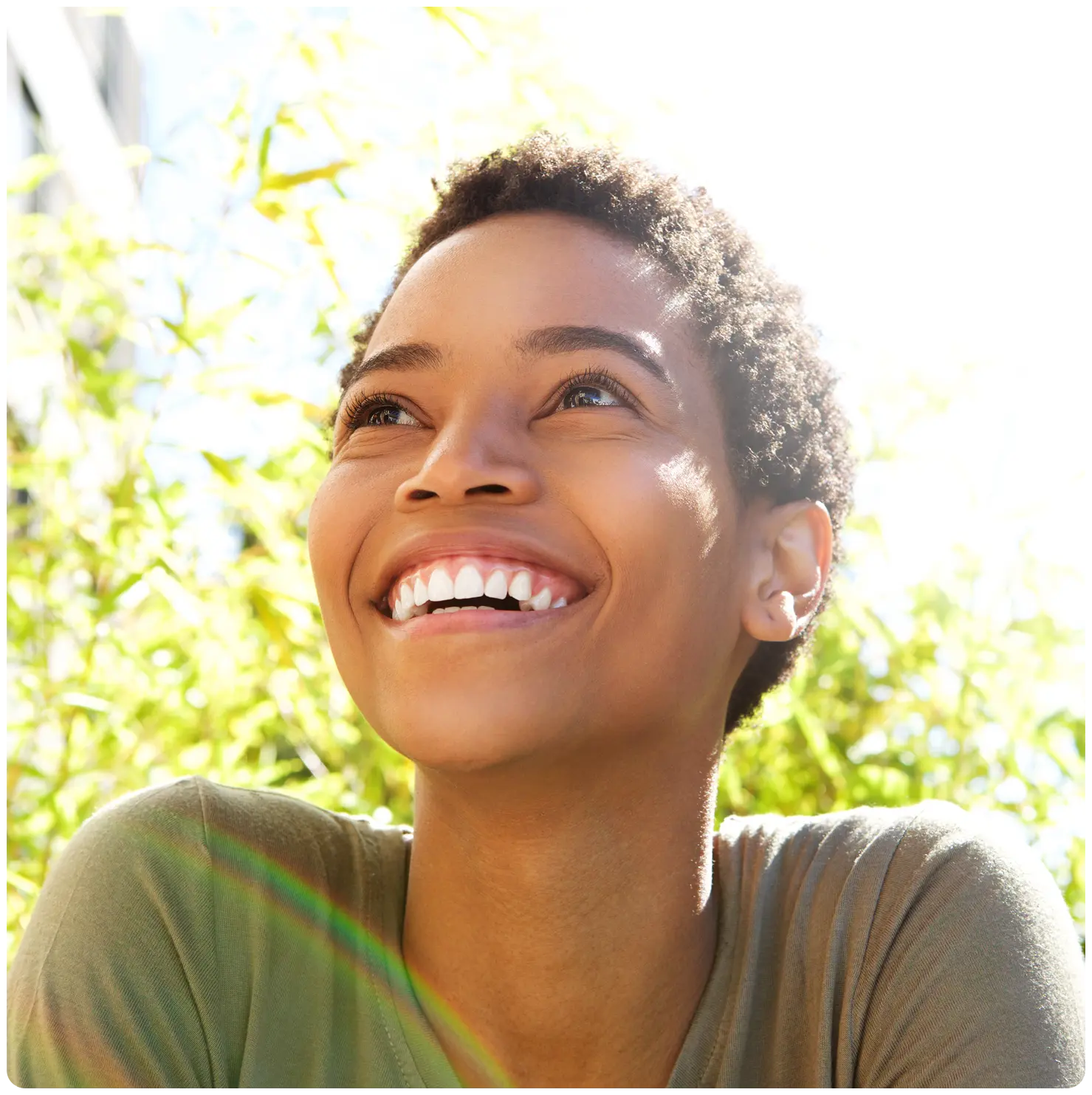 A woman breathes in deeply through her nose.