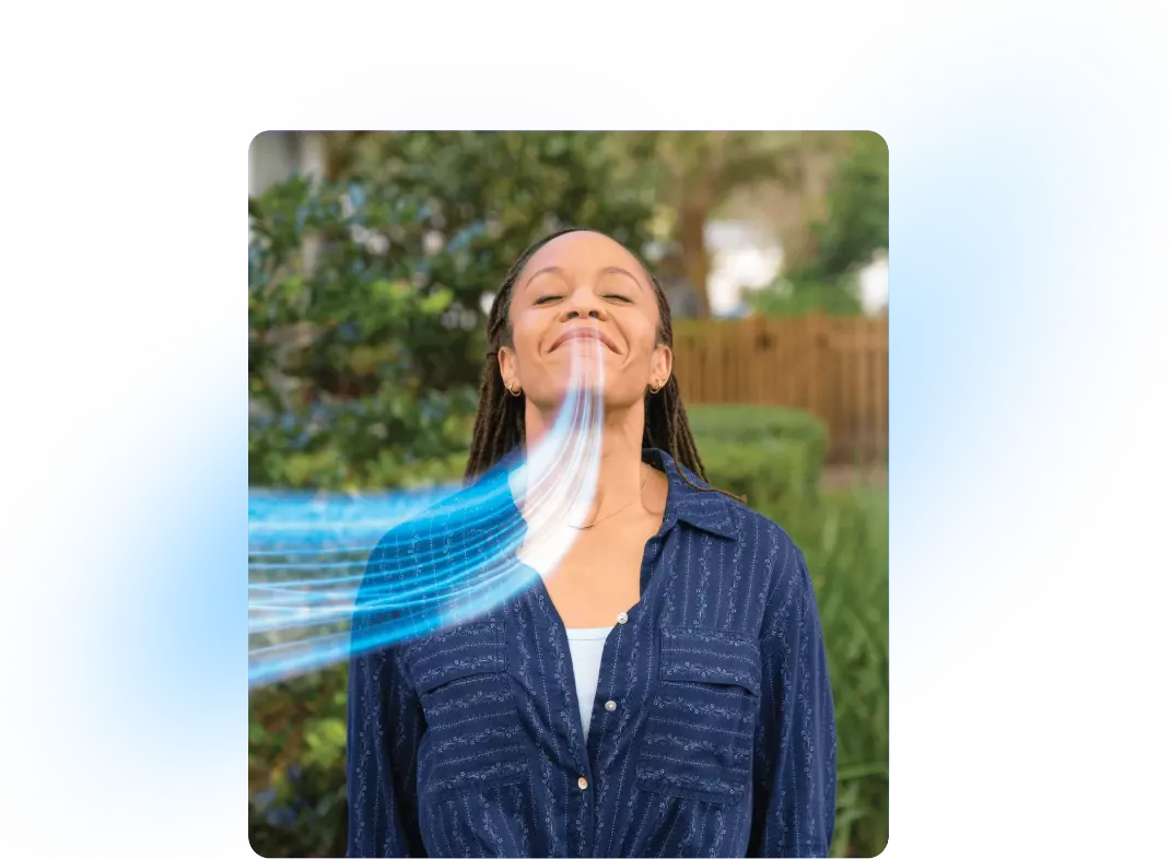 A woman breathes in deeply through her nose.